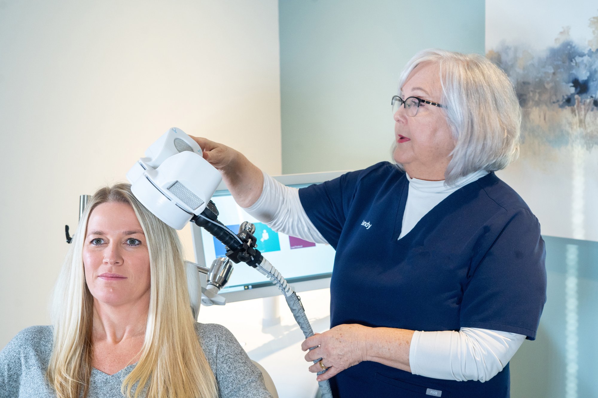 clinician-placing-tms-coil-on-patient-head-2