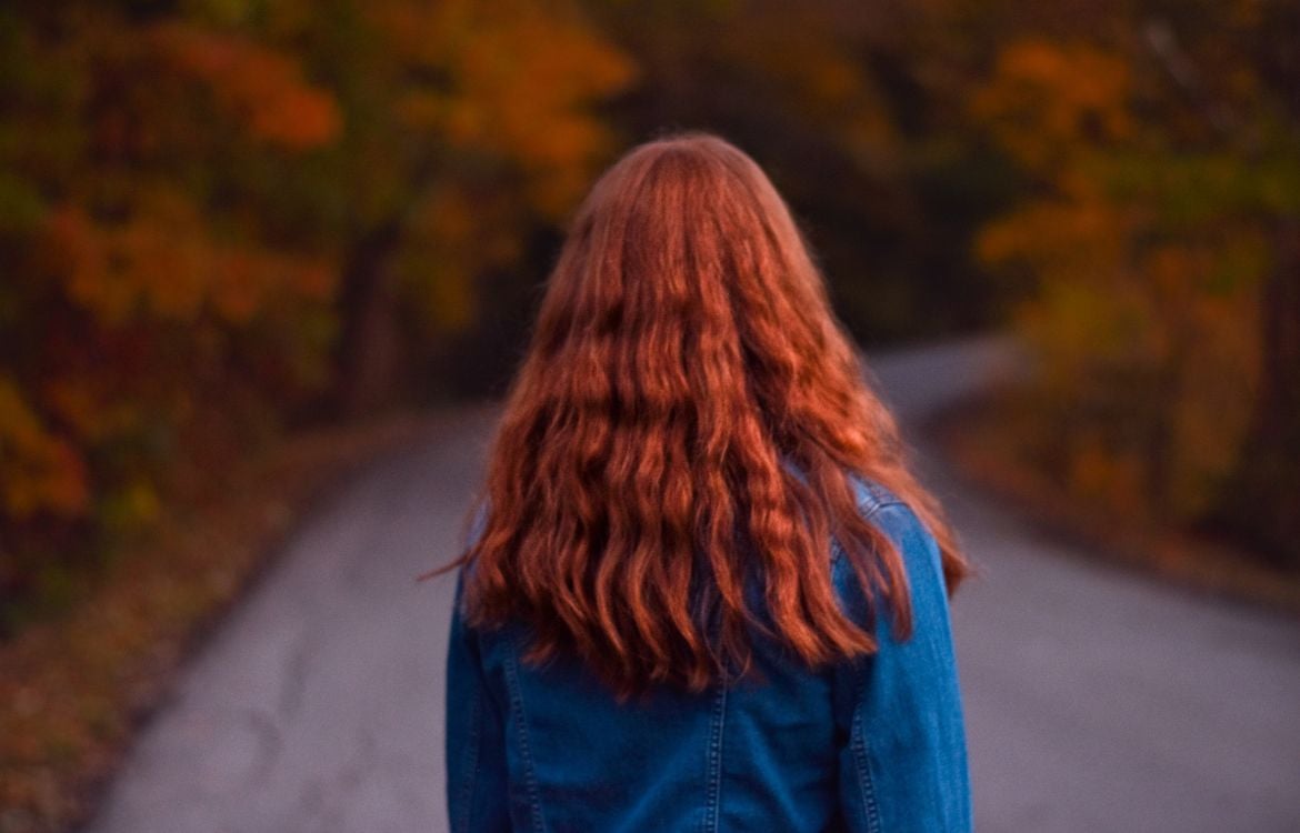 A woman contemplates a path ahead